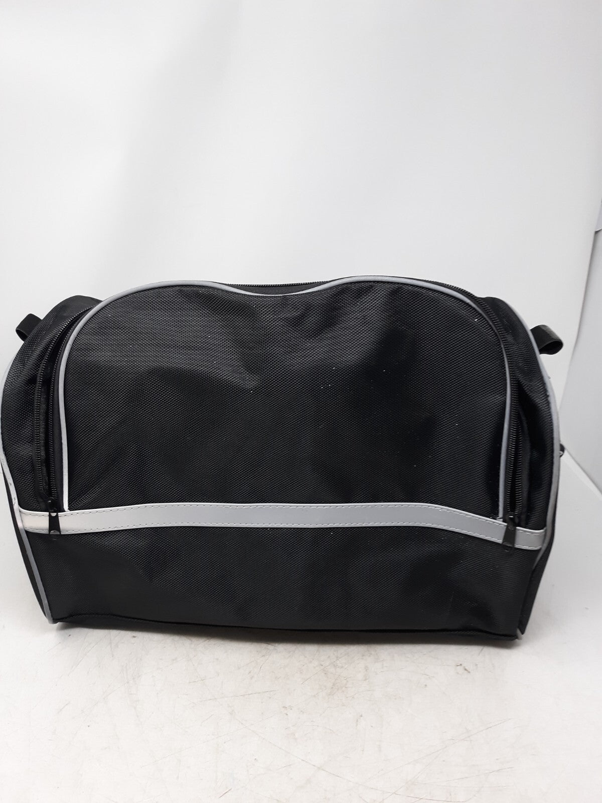 black travel bag with a zippered main compartment and mesh interior