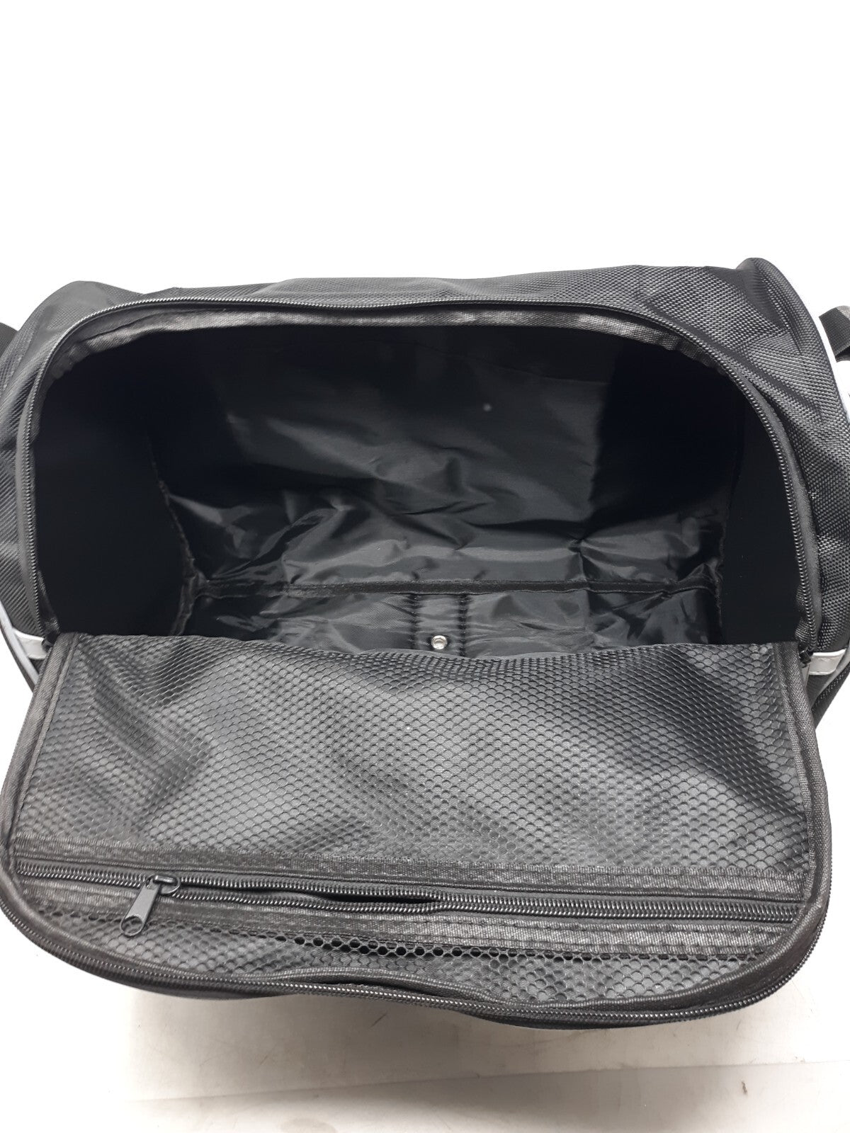 black travel bag with a zippered main compartment and mesh interior