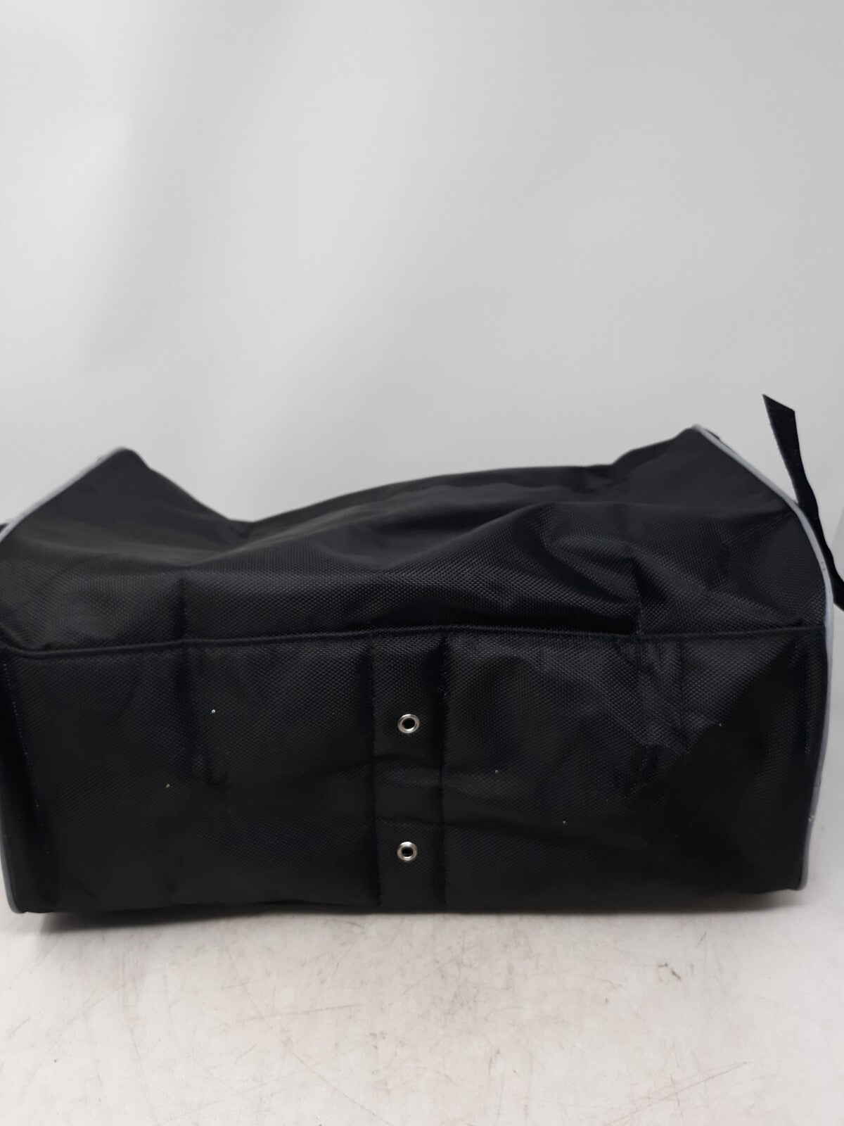 black travel bag with a zippered main compartment and mesh interior