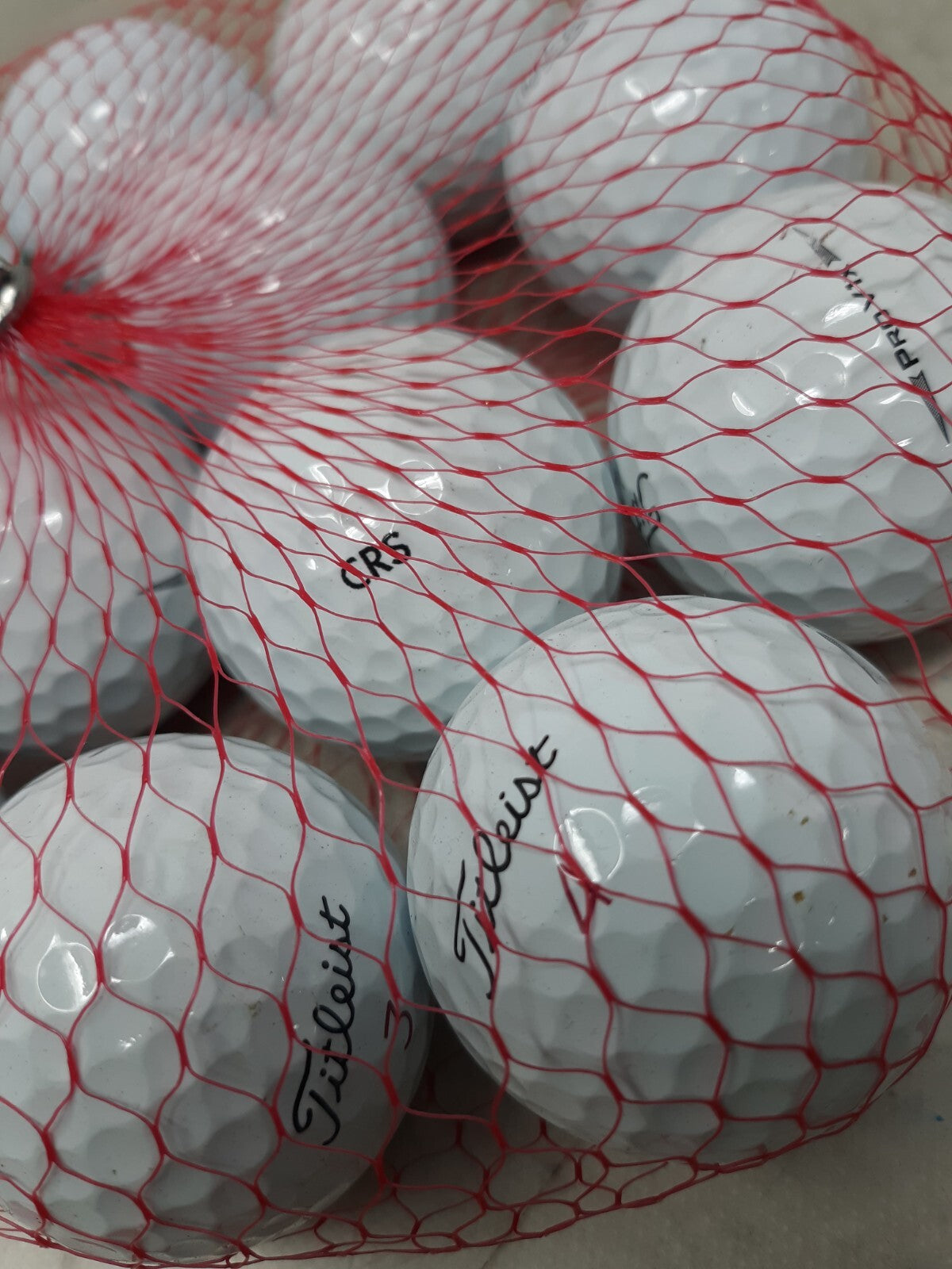 Titleist one dozen golf balls assorted.