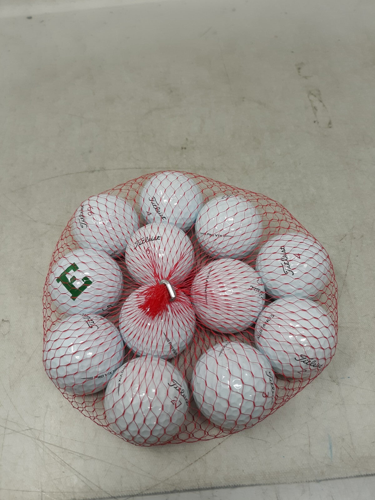 Titleist one dozen golf balls assorted.